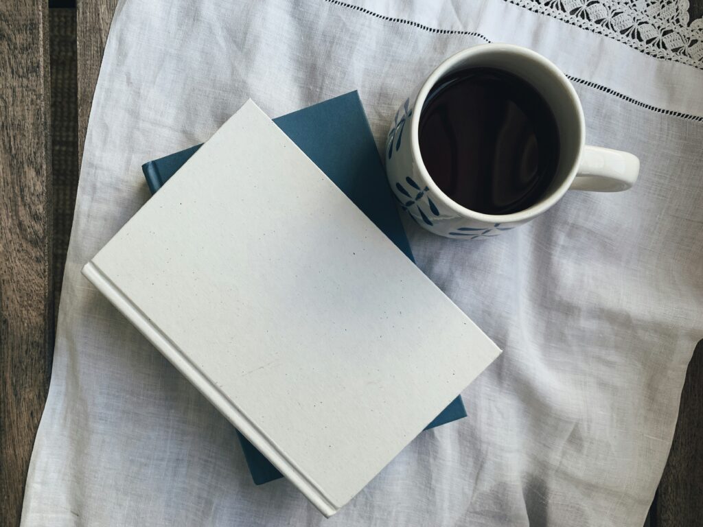 A coffee mug and a journal laid out - a week of content ideas for Mental Health Week Canada 2024, designed for nonprofit and charity marketing efforts.
