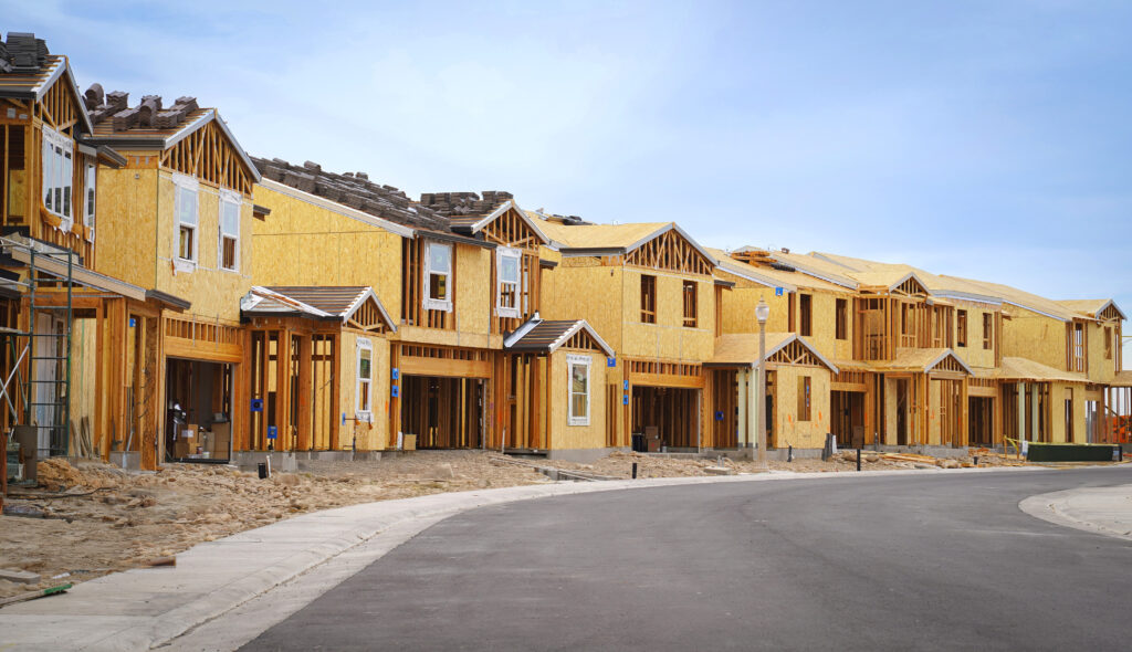 Condo of yellow houses with blue sky