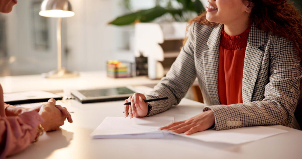 Contract, woman and hands of advisor for interview, information or document for job application. Advice, client or human resource agent with paperwork for registration, opportunity or deal agreement